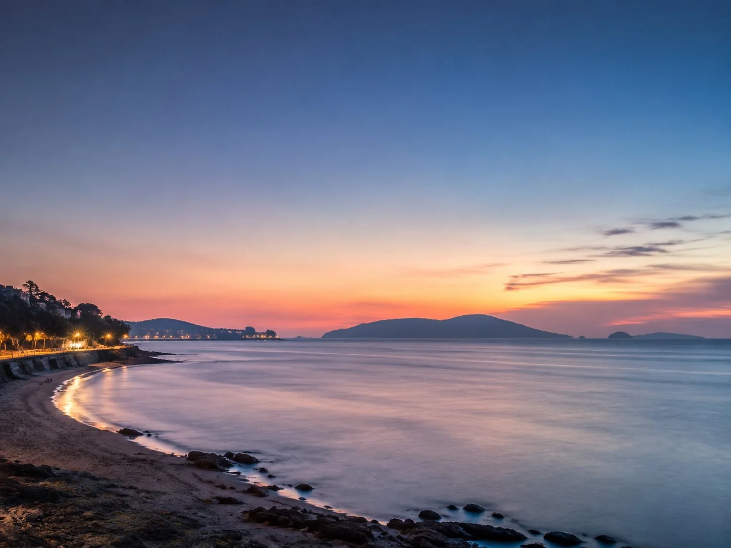 The Xiamen coast at dusk with an island silhouette offshore